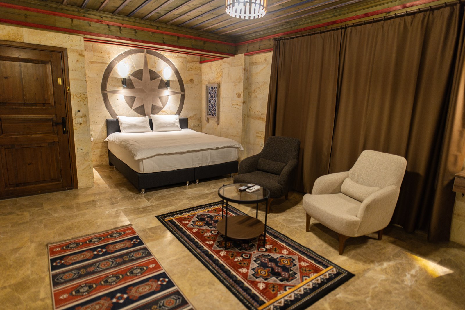 Warm cave-inspired boutique hotel room with stone walls
